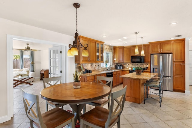 dining space featuring sink, a wealth of natural light, and light tile patterned floors