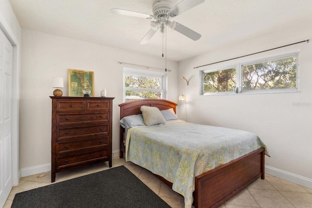 tiled bedroom featuring ceiling fan