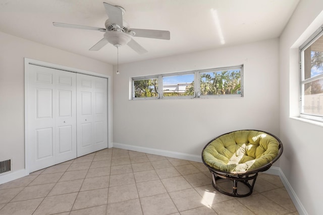 unfurnished room featuring light tile patterned floors and ceiling fan