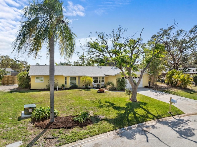 ranch-style house with a garage and a front lawn