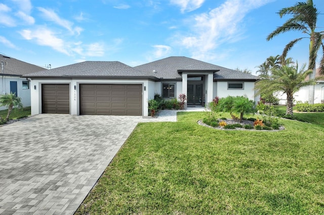 prairie-style home with a garage and a front lawn