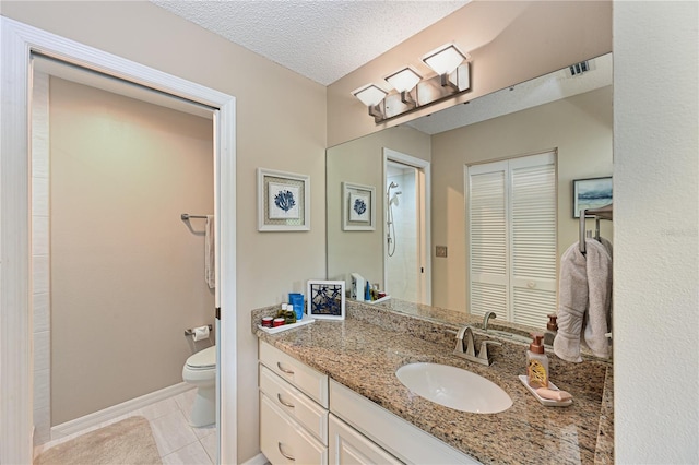 bathroom featuring visible vents, toilet, a textured ceiling, vanity, and tile patterned flooring