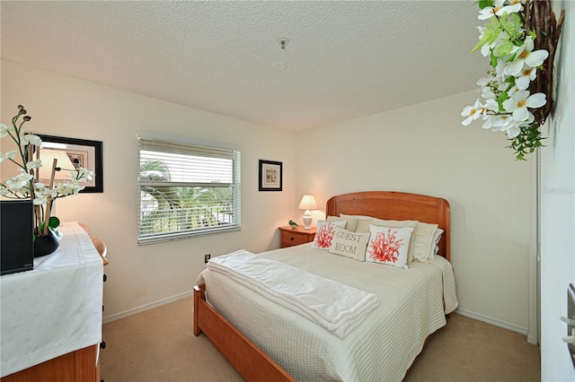 carpeted bedroom with a textured ceiling