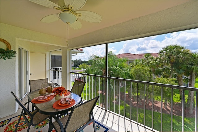 balcony with ceiling fan and a sunroom