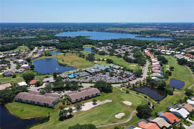 aerial view with view of golf course, a water view, and a residential view