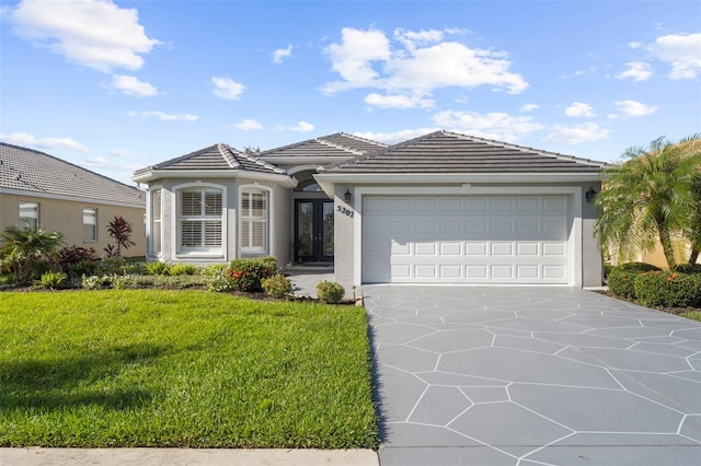 view of front of property with a front yard and a garage