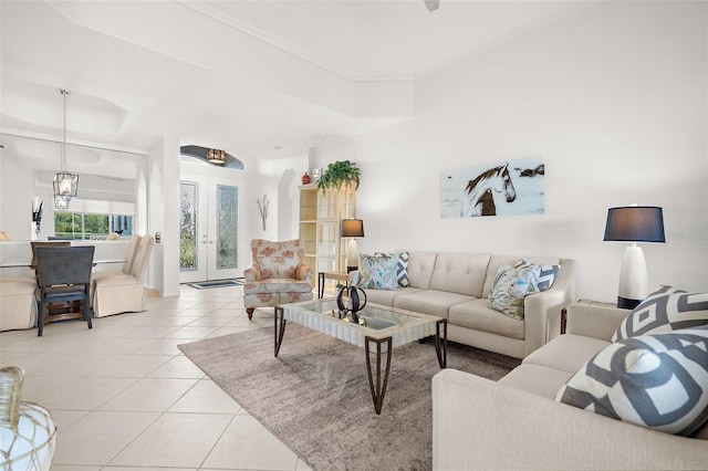 living room featuring light tile patterned flooring, an inviting chandelier, and french doors