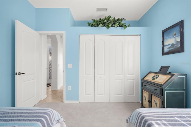 bedroom with light colored carpet and a closet