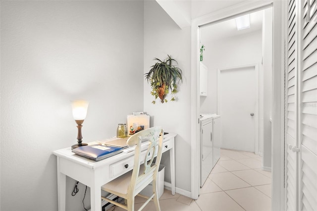 office area with independent washer and dryer and light tile patterned floors