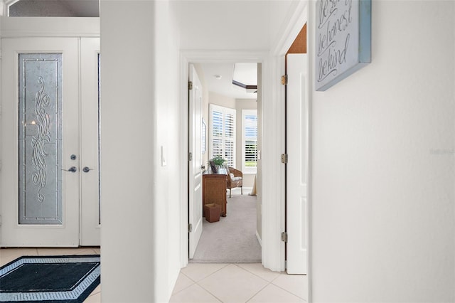 hall featuring light tile patterned floors