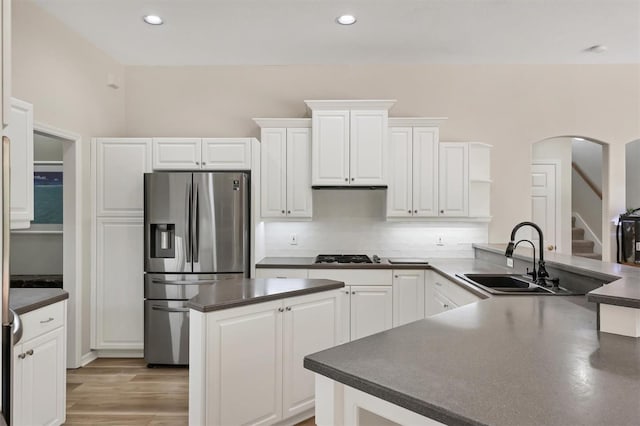 kitchen featuring white cabinets, stainless steel appliances, tasteful backsplash, and sink