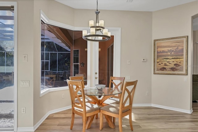 dining space with an inviting chandelier and light wood-type flooring