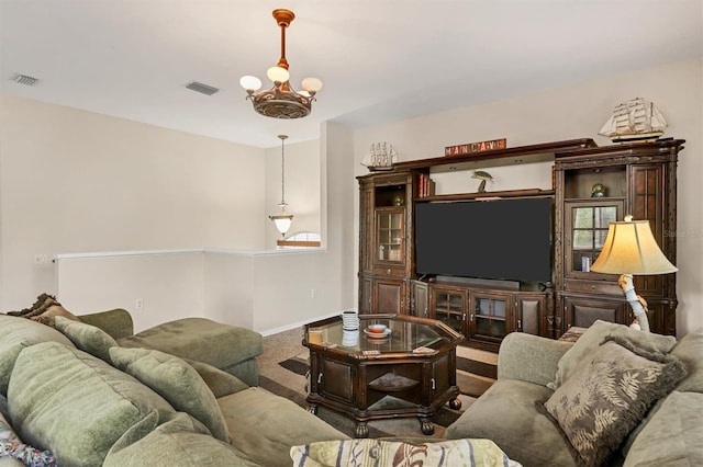 living room featuring carpet and an inviting chandelier