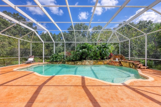 view of swimming pool featuring a lanai and a patio area