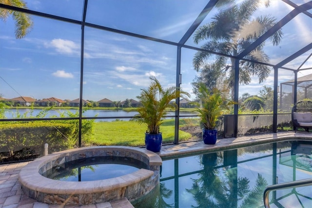 view of pool featuring an in ground hot tub, a water view, and a lanai