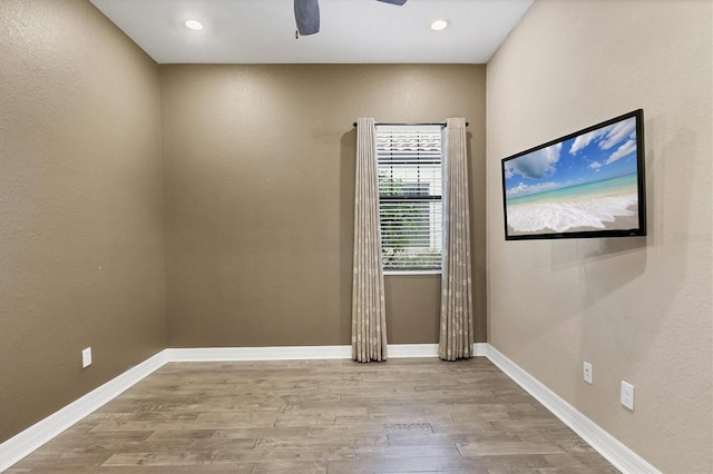 spare room featuring ceiling fan and light hardwood / wood-style flooring