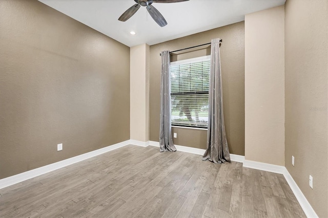 spare room featuring light hardwood / wood-style flooring and ceiling fan