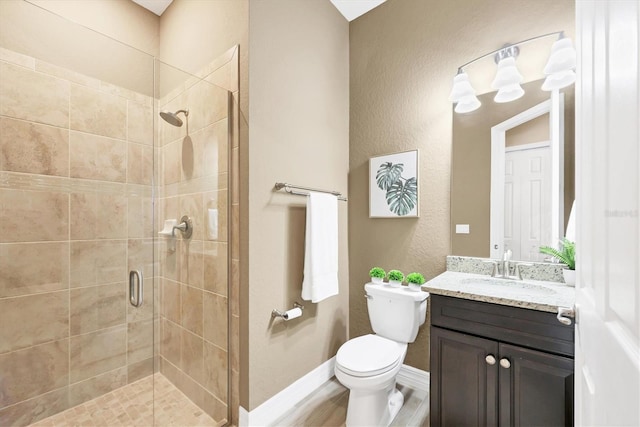 bathroom featuring vanity, toilet, a shower with shower door, and wood-type flooring