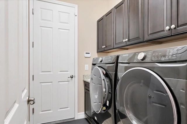 laundry area featuring cabinets and washing machine and dryer