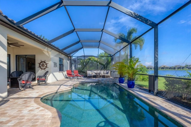 view of swimming pool featuring a lanai, ceiling fan, a water view, and a patio