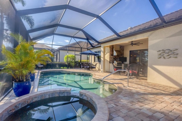 view of swimming pool with an in ground hot tub, a patio, ceiling fan, and a lanai