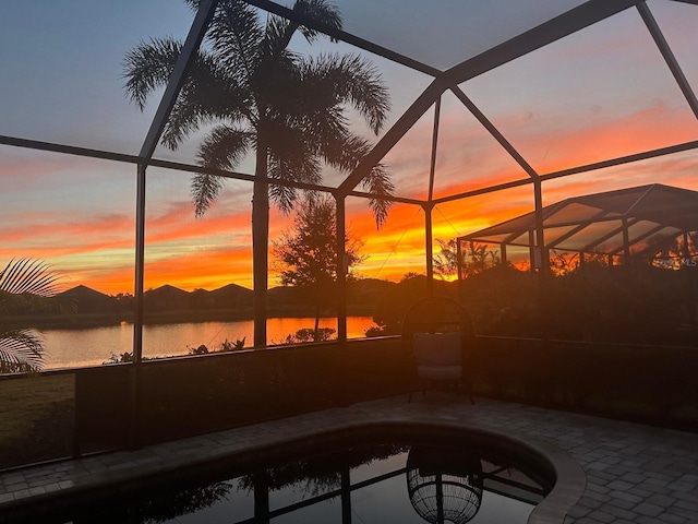 exterior space with a lanai and a water view