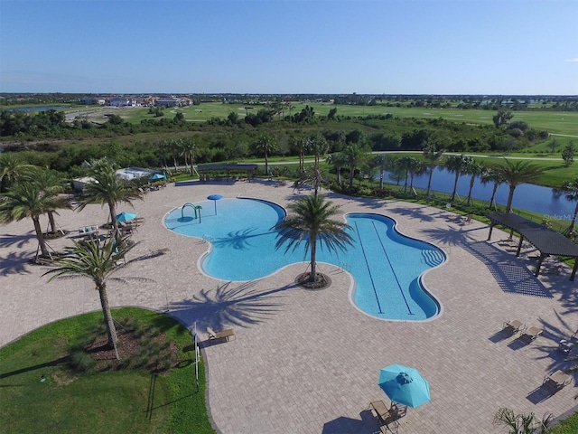 view of swimming pool featuring a patio area and a water view