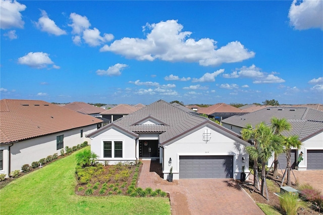 view of front of house featuring a front yard and a garage