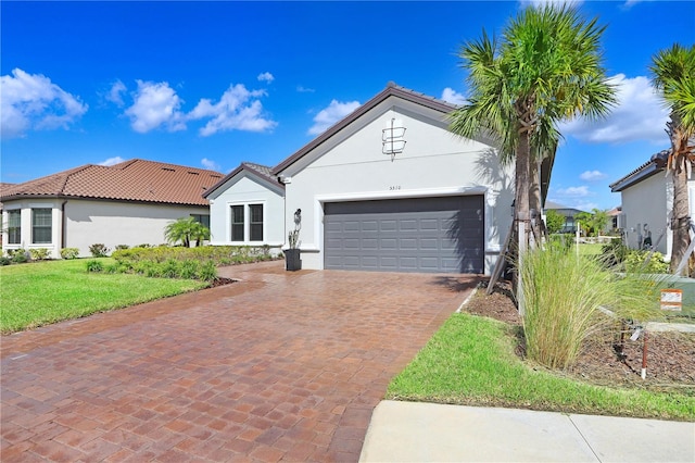 view of front of property with a front lawn and a garage