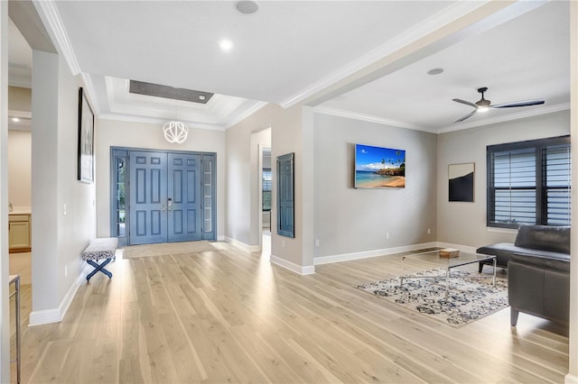 foyer with light hardwood / wood-style floors, crown molding, and plenty of natural light