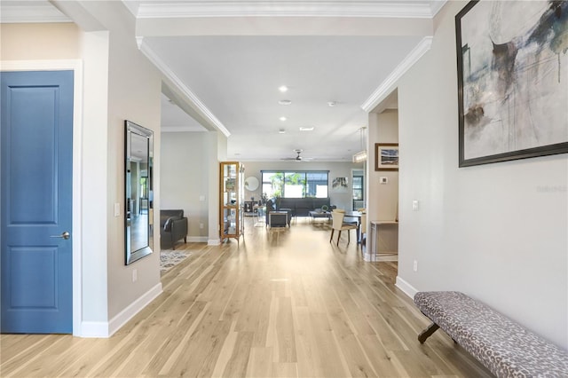 hallway with crown molding and light wood-type flooring