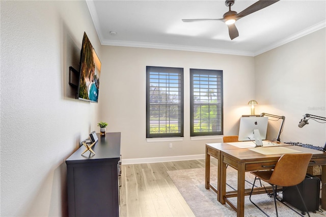 home office with ceiling fan, crown molding, and light wood-type flooring