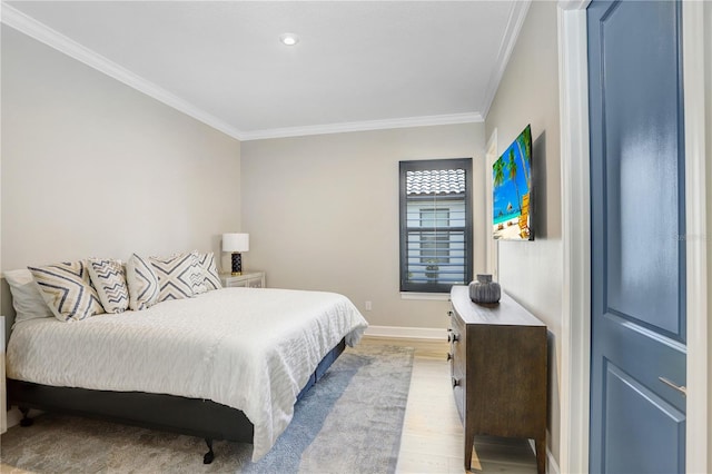 bedroom featuring ornamental molding and light hardwood / wood-style floors