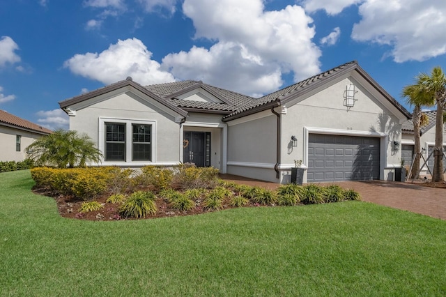 view of front of house featuring a garage and a front lawn