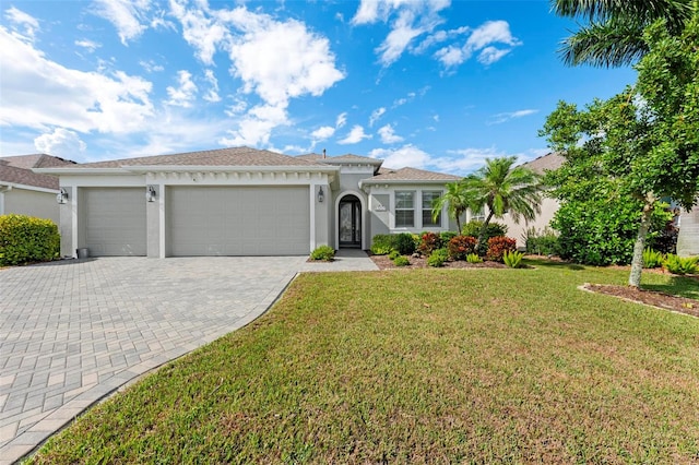 mediterranean / spanish home with a front lawn and a garage