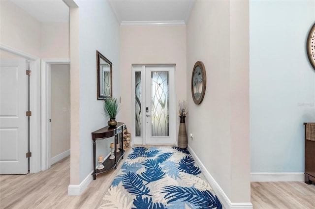 entrance foyer with light wood-type flooring and crown molding