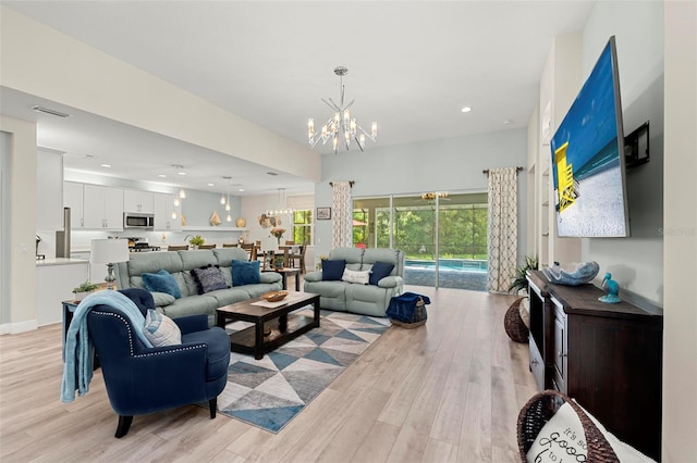 living room featuring light hardwood / wood-style flooring and a chandelier