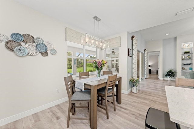 dining space featuring light wood-type flooring and ceiling fan