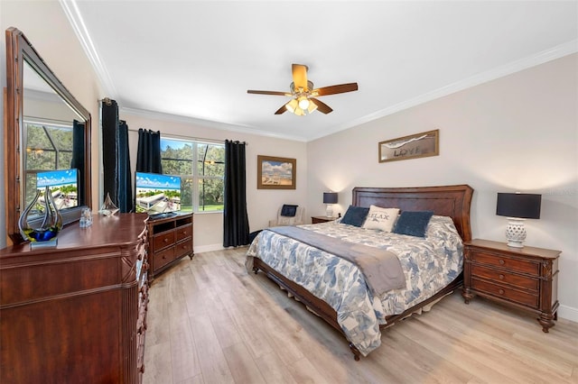 bedroom featuring ceiling fan, light hardwood / wood-style flooring, ornamental molding, and multiple windows