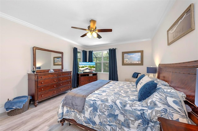 bedroom featuring light hardwood / wood-style flooring, ceiling fan, and ornamental molding