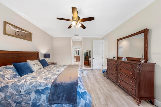 bedroom featuring ceiling fan, light hardwood / wood-style flooring, ensuite bath, and ornamental molding