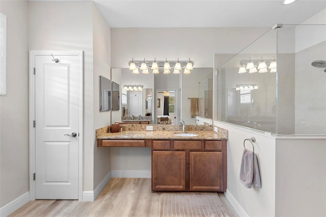 bathroom featuring hardwood / wood-style flooring, a shower, and vanity