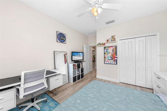 bedroom with ceiling fan, a closet, and light hardwood / wood-style floors