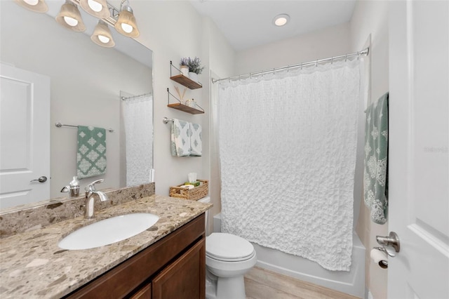 full bathroom with vanity, hardwood / wood-style floors, toilet, and shower / bathtub combination with curtain