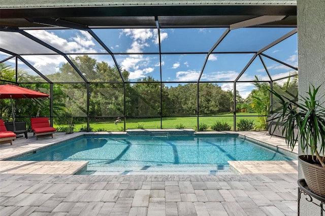 view of pool with a patio and glass enclosure