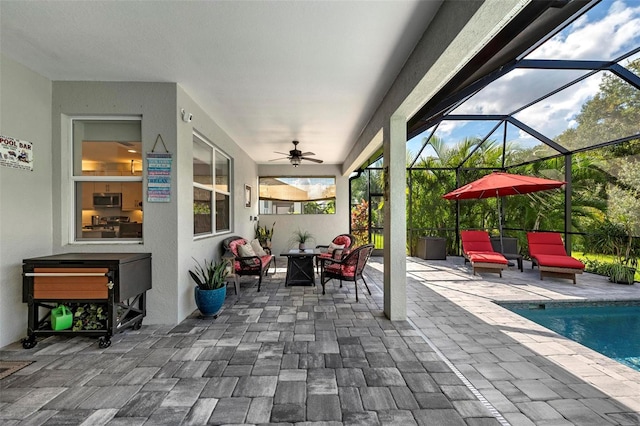 view of patio featuring outdoor lounge area, a lanai, and ceiling fan