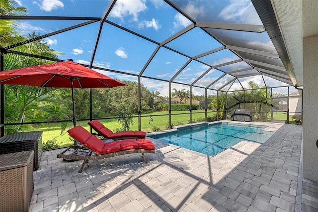 view of swimming pool with a lawn, glass enclosure, and a patio area