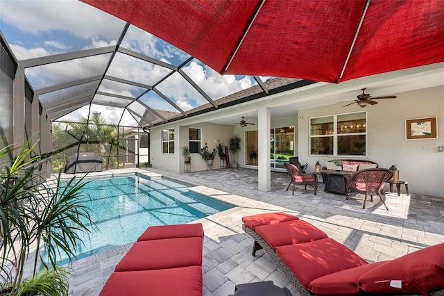 view of pool with a lanai, a patio, and ceiling fan