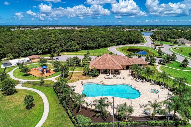 view of swimming pool featuring a patio and a water view