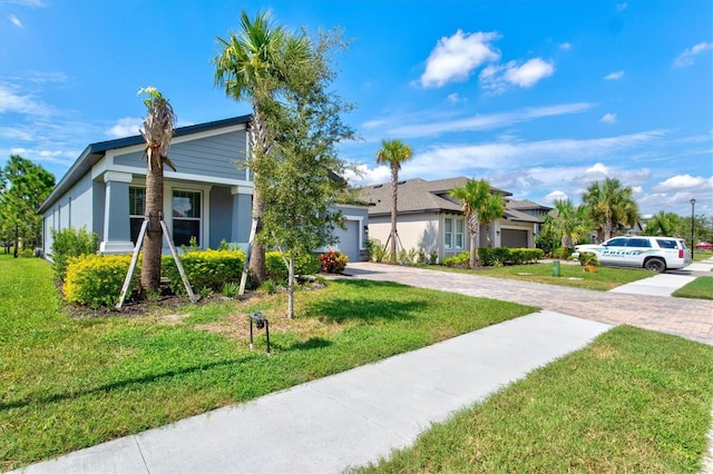 view of front facade with a front yard and a garage